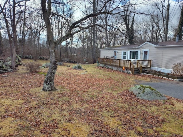 view of yard featuring a wooden deck