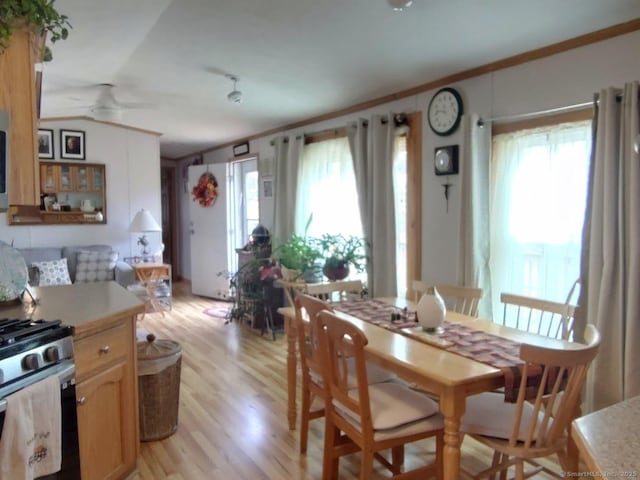 dining space with ornamental molding, ceiling fan, and light wood-type flooring