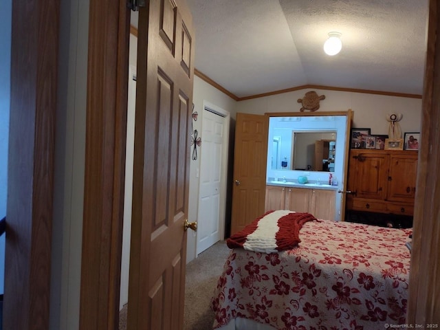 bedroom with ornamental molding, lofted ceiling, carpet floors, and a textured ceiling