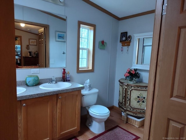 bathroom featuring ornamental molding, vanity, toilet, and hardwood / wood-style floors