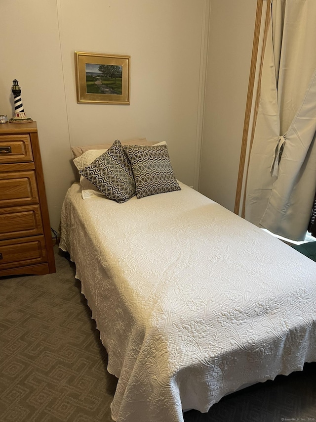 bedroom with dark colored carpet