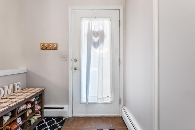 doorway to outside featuring dark tile patterned floors and baseboard heating