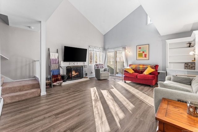 living room with dark wood-type flooring and high vaulted ceiling