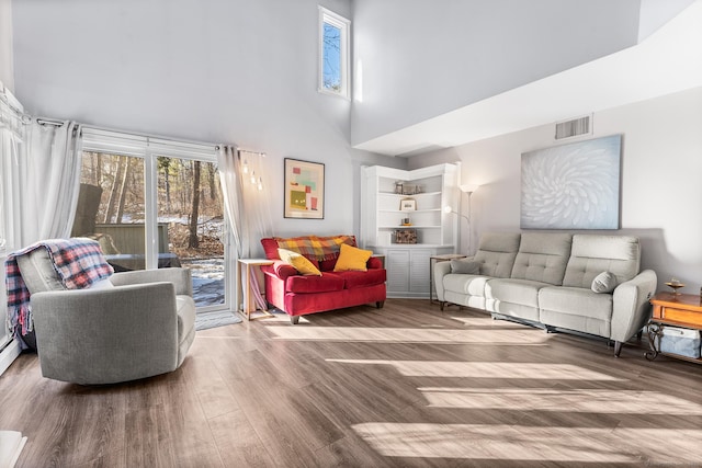 living room featuring hardwood / wood-style flooring and a high ceiling