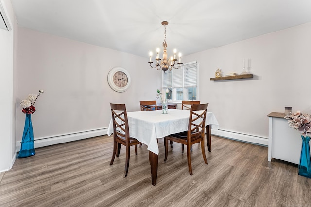 dining room featuring an inviting chandelier, hardwood / wood-style floors, and baseboard heating