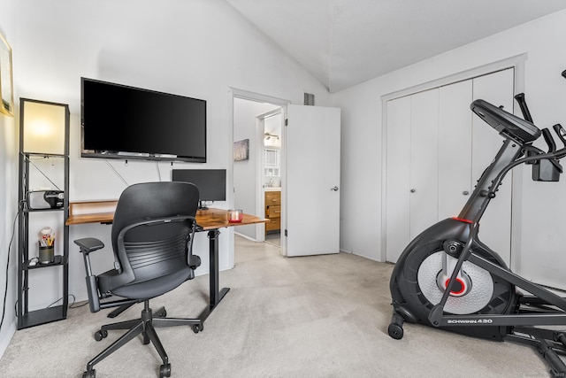 carpeted office space with vaulted ceiling