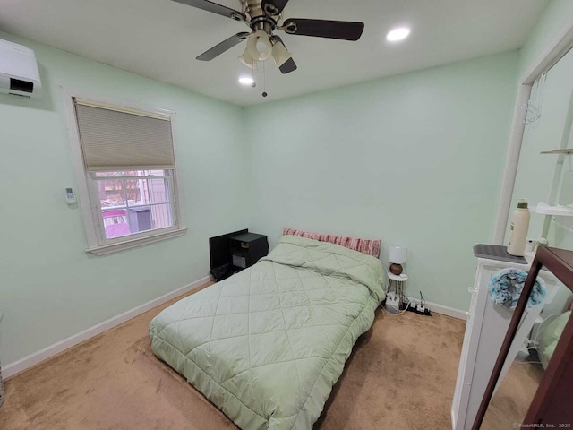 carpeted bedroom with a wall mounted air conditioner and ceiling fan