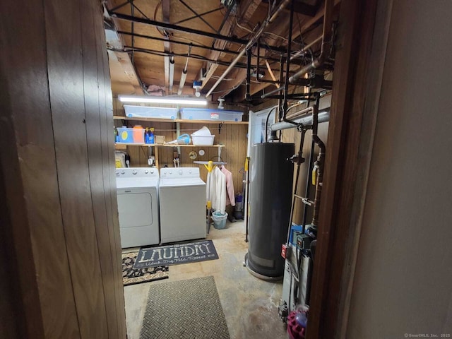 washroom with water heater and washing machine and clothes dryer