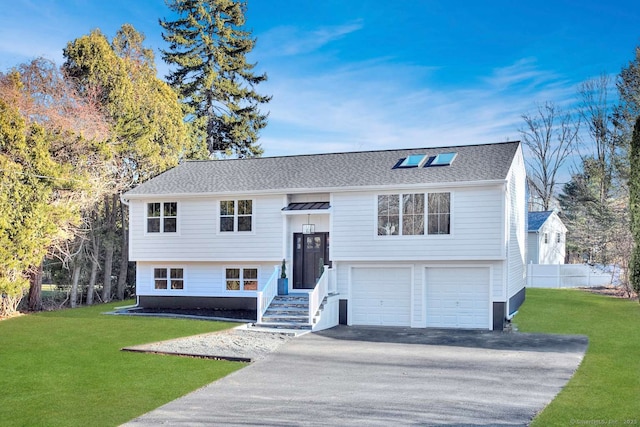 split foyer home featuring a garage and a front lawn