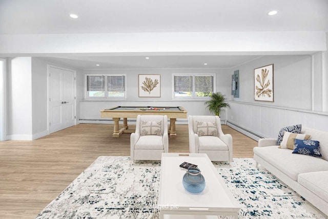 living room with light hardwood / wood-style floors, a wealth of natural light, baseboard heating, and billiards