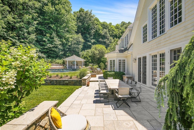 view of patio / terrace with french doors and an outbuilding