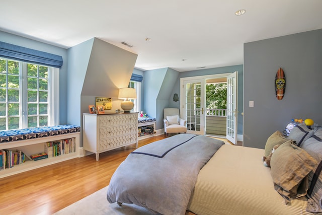 bedroom with hardwood / wood-style flooring and access to exterior