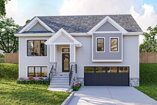 split foyer home featuring a garage, a front yard, driveway, and fence