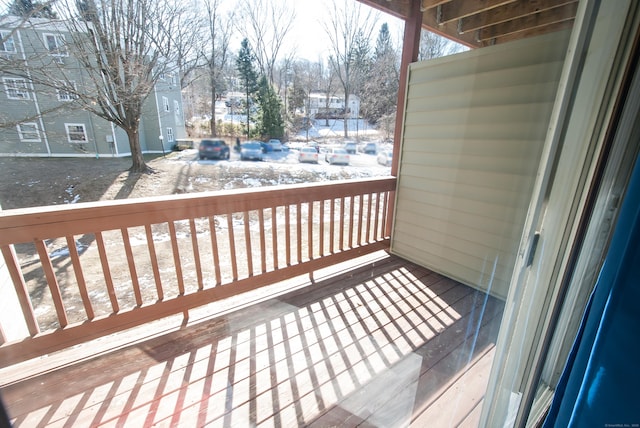 view of snow covered back of property