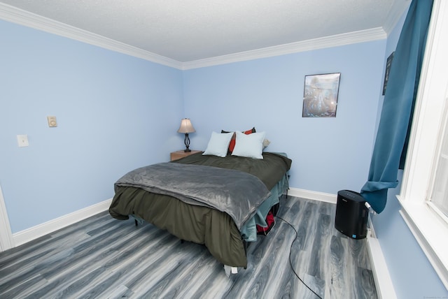 bedroom with ornamental molding and dark hardwood / wood-style floors