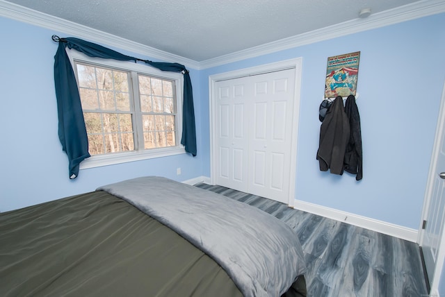 bedroom with crown molding, a closet, dark hardwood / wood-style floors, and a textured ceiling