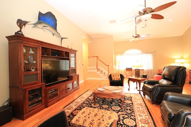 living room featuring light hardwood / wood-style flooring and ceiling fan