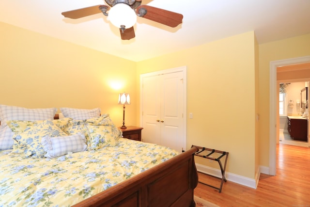 bedroom featuring ceiling fan, light wood-type flooring, and a closet