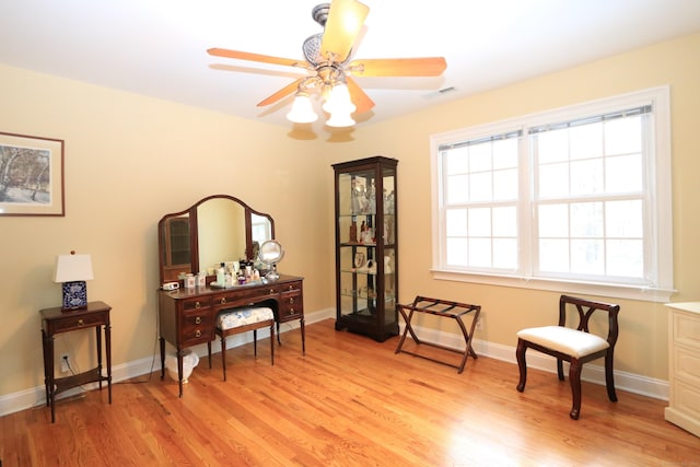 living area featuring ceiling fan and light hardwood / wood-style flooring