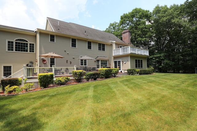 rear view of house featuring a lawn