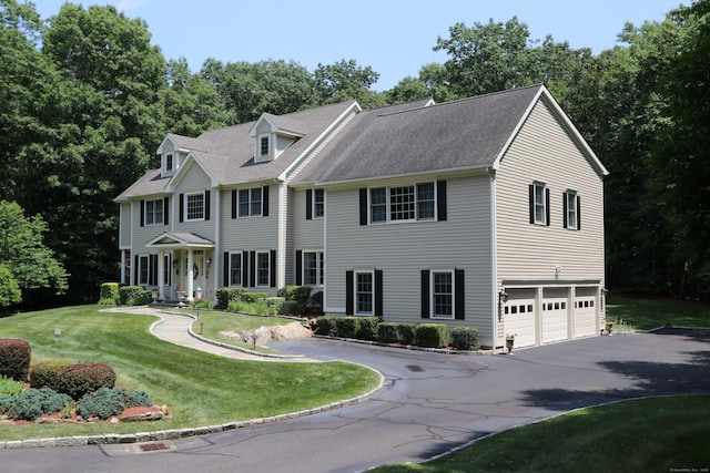 colonial home with a garage and a front yard