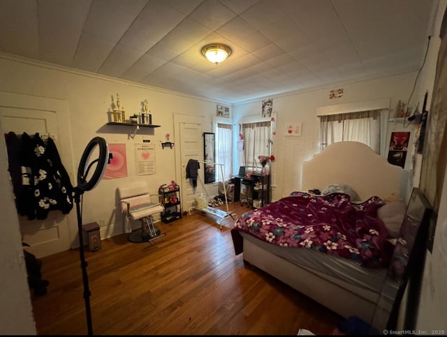 bedroom featuring hardwood / wood-style flooring and ornamental molding