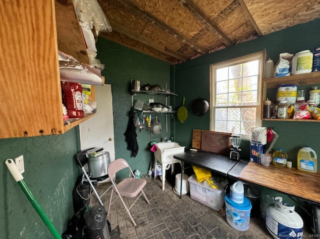 miscellaneous room with lofted ceiling