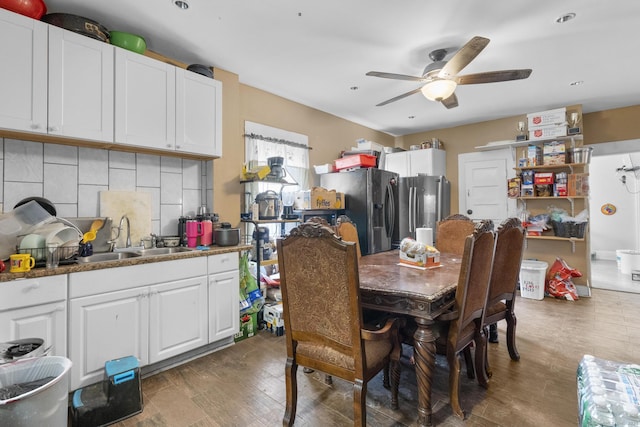 dining area with ceiling fan, dark hardwood / wood-style floors, and sink