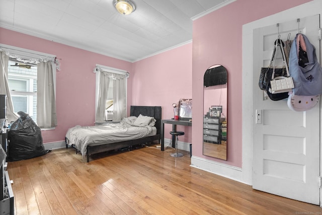 bedroom featuring hardwood / wood-style flooring and crown molding