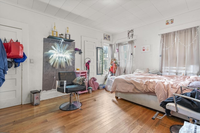 bedroom featuring hardwood / wood-style floors and crown molding