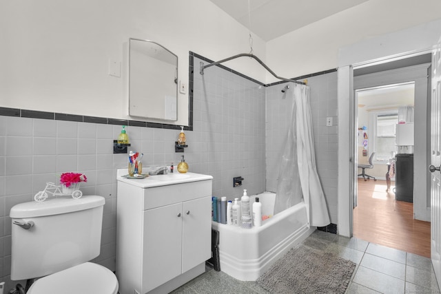 full bathroom featuring tile walls, tile patterned flooring, vanity, toilet, and shower / bath combo with shower curtain