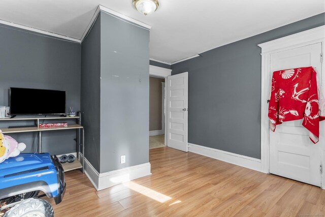 interior space with crown molding and wood-type flooring