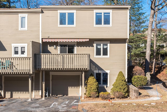 multi unit property with a balcony and a garage