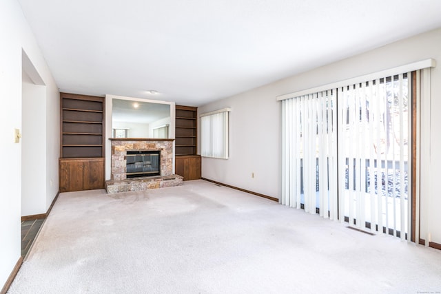 unfurnished living room featuring a fireplace and carpet floors