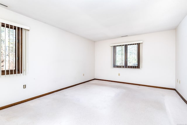 carpeted empty room with plenty of natural light