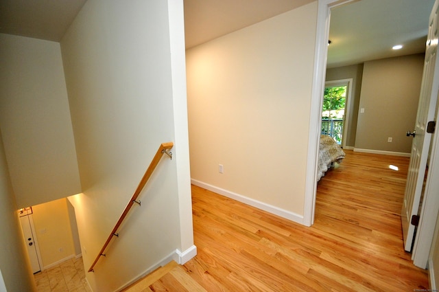 staircase with hardwood / wood-style flooring