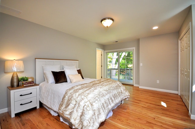 bedroom featuring access to exterior, light hardwood / wood-style floors, and a closet