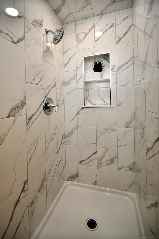 bathroom with tiled shower