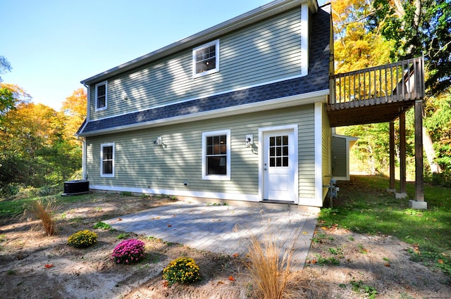 rear view of property with a patio, a deck, and central AC unit