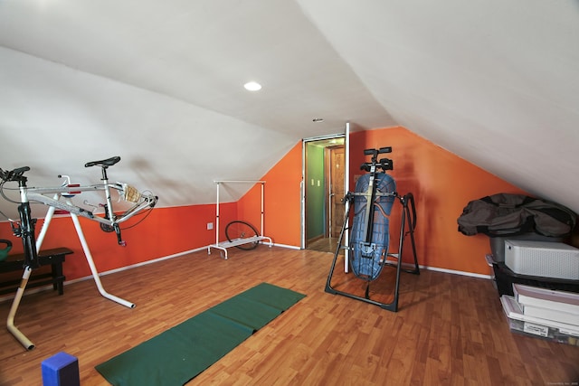 workout room featuring lofted ceiling and hardwood / wood-style floors