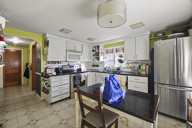 kitchen with white cabinetry, sink, and stainless steel appliances