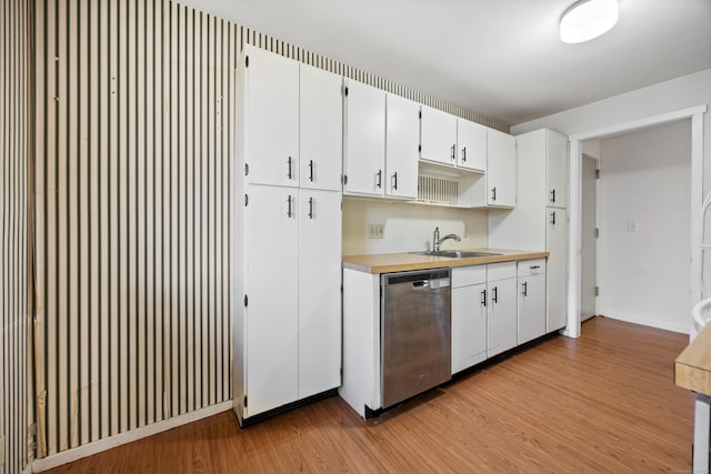 kitchen featuring sink, stainless steel dishwasher, white cabinets, and light wood-type flooring