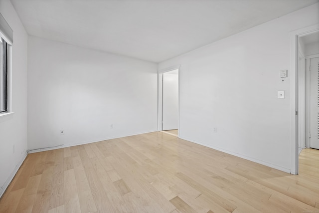 spare room with light hardwood / wood-style flooring