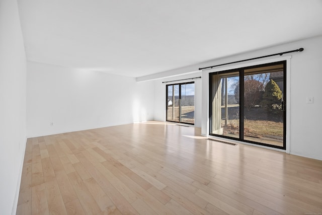 unfurnished room with light wood-type flooring