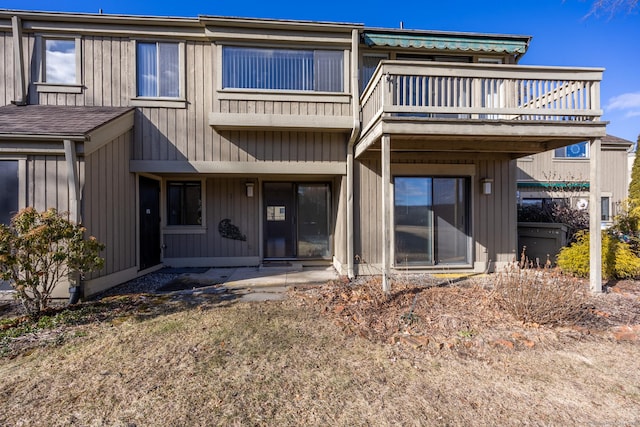 back of house featuring a balcony and a patio