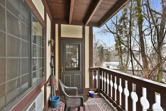 view of snow covered back of property