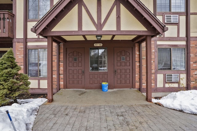 doorway to property featuring an AC wall unit