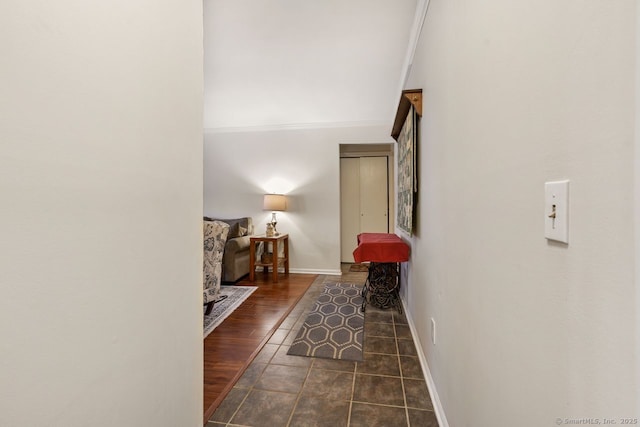 corridor featuring dark hardwood / wood-style flooring and crown molding