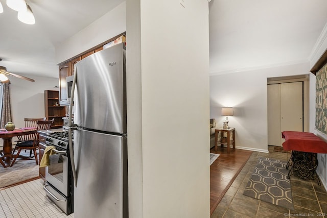 kitchen featuring dark hardwood / wood-style flooring, appliances with stainless steel finishes, crown molding, and ceiling fan