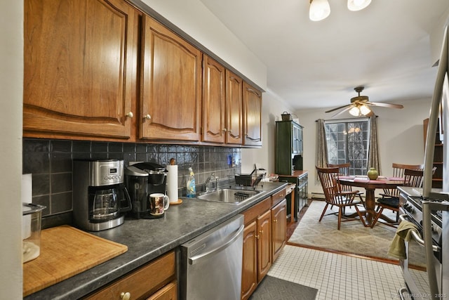 kitchen featuring tasteful backsplash, sink, oven, stainless steel dishwasher, and crown molding